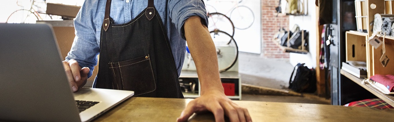 Man using laptop in shop